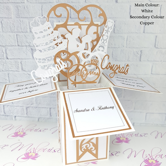 Copper coloured pop up box card with wedding themed elements.